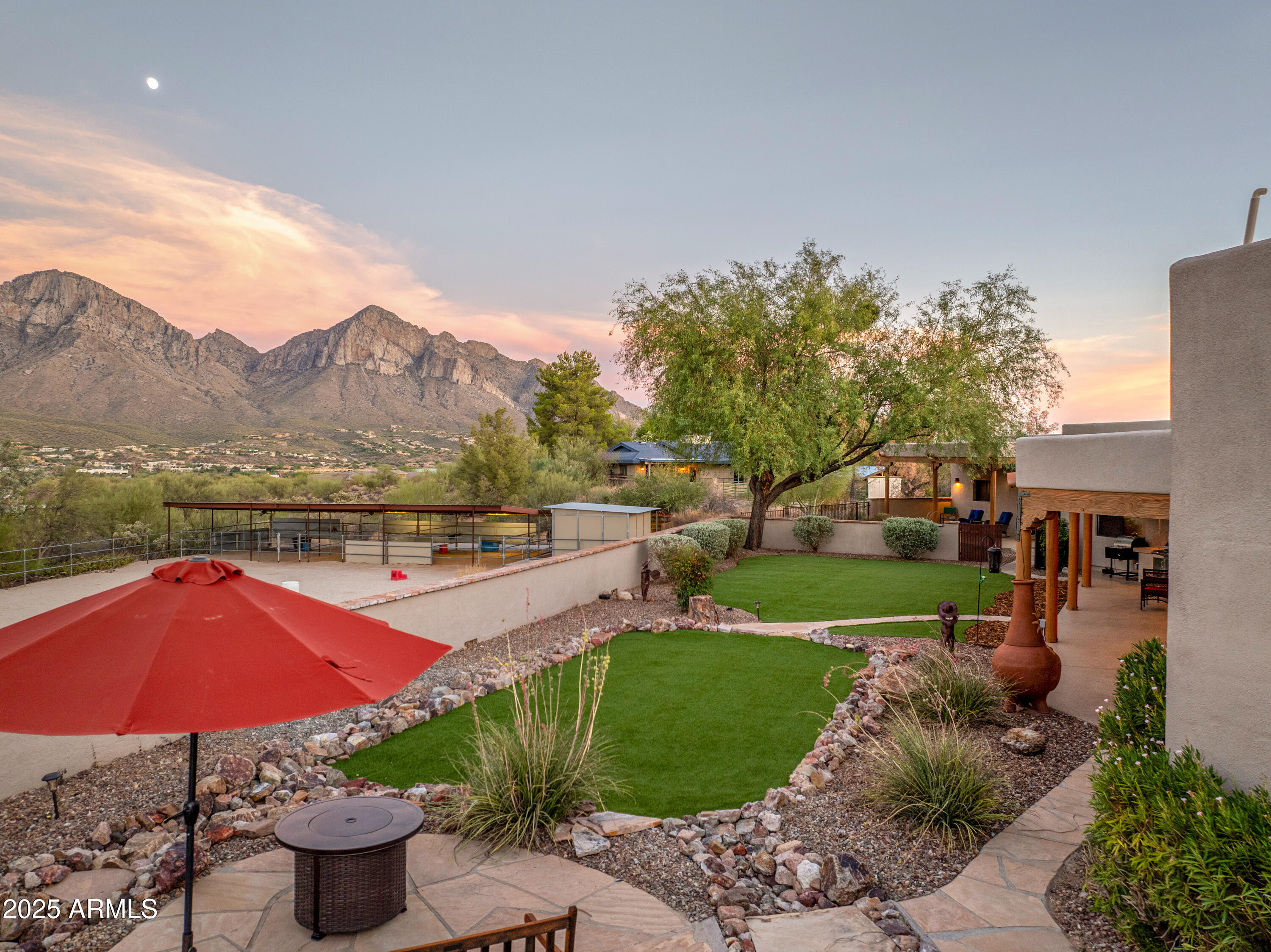 11484 North 1st Avenue Tucson, AZ 85737 - Photo 7 of 47 a view of a swimming pool with a table and chairs under an umbrella