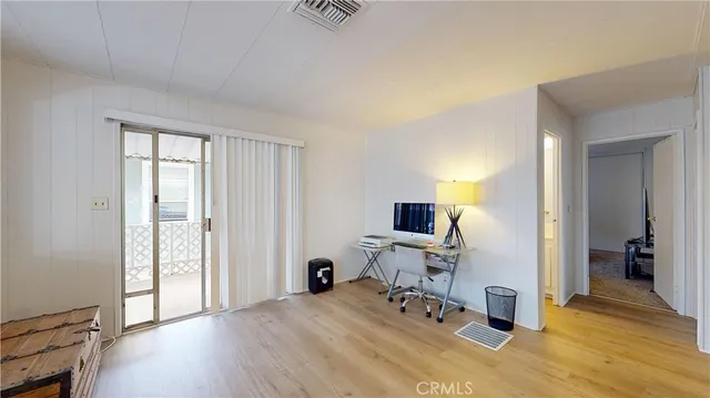 a view of a livingroom with workspace and a window