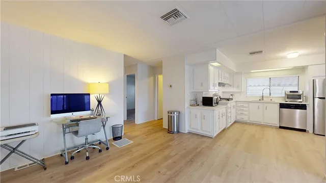 a living room with furniture and kitchen view