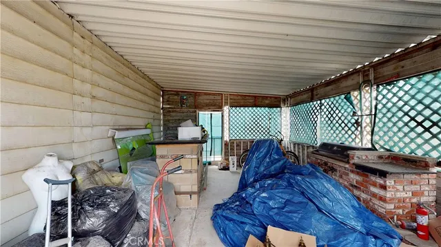 a roof deck with table and chairs and potted plants