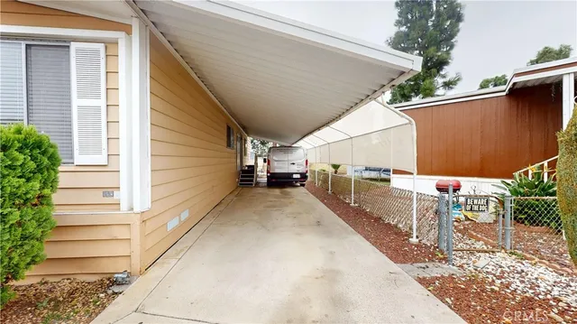 a view of a balcony with wooden floor and fence