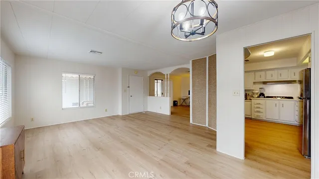 a view of a room with wooden floor and a window