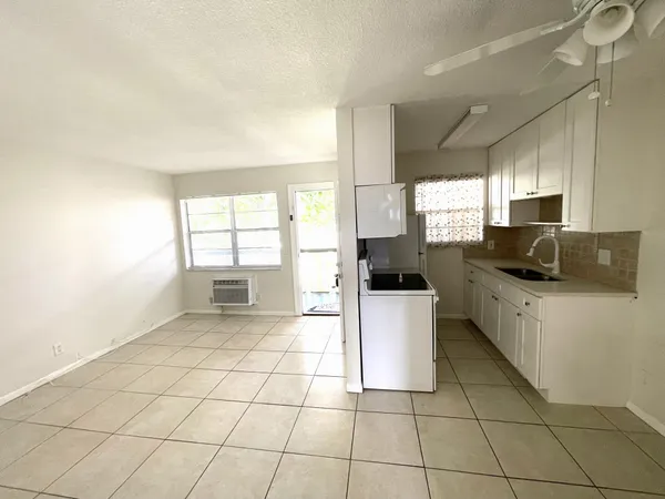 a kitchen with a white cabinets and white appliances