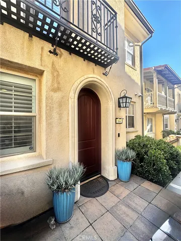a view of a house with potted plants