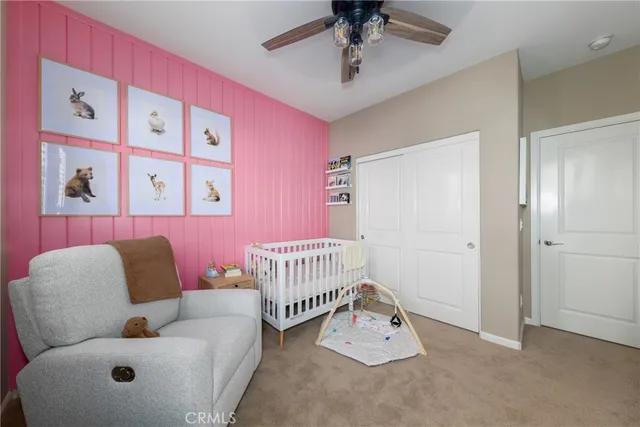 a bedroom with furniture and a large window