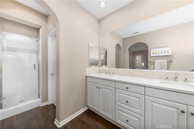 a bathroom with a double vanity sink and mirror