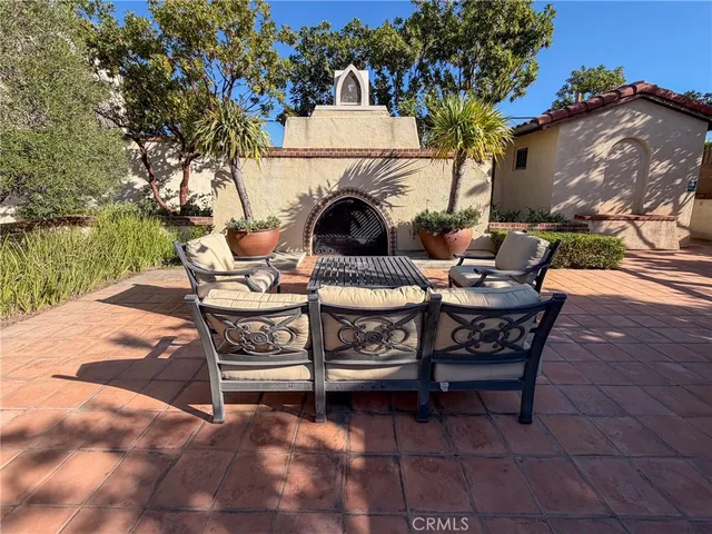 a view of a chairs and table in the back yard of the house