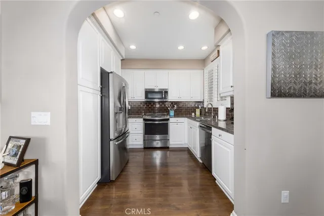 a kitchen with kitchen island granite countertop lots of counter top space and stainless steel appliances