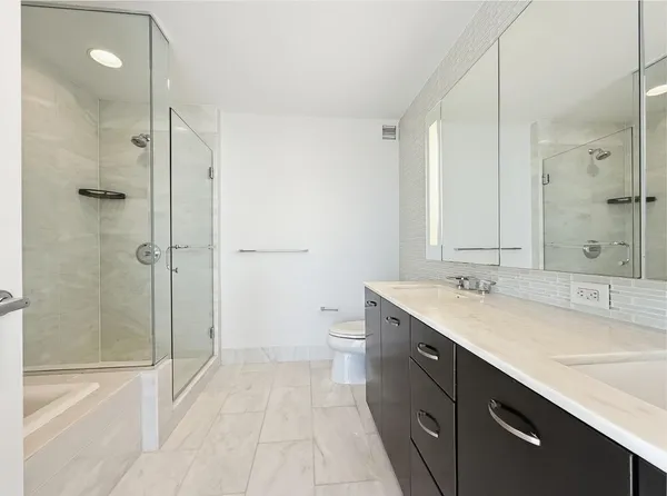a bathroom with a bathtub and a shower
