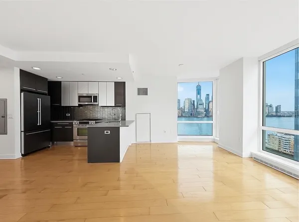a large kitchen with stainless steel appliances kitchen island granite countertop a stove top oven a sink and dishwasher