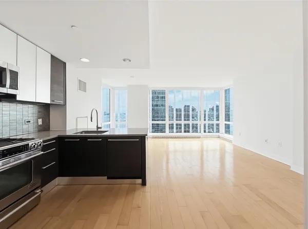 a large kitchen with granite countertop a stove and a sink
