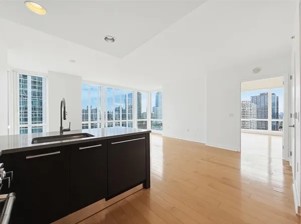 a kitchen with a sink and large window