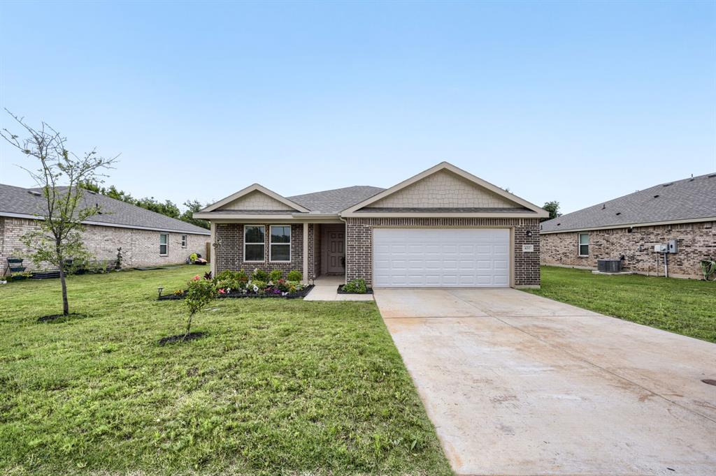 420 Jameson Springtown, TX 76082 - Photo 25 of 29 a front view of a house with a yard and garage