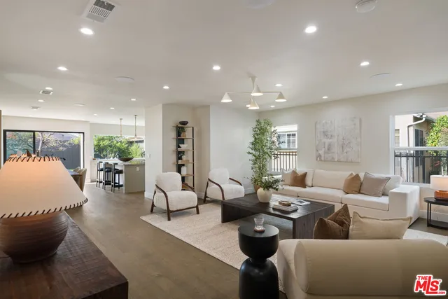 a kitchen with kitchen island a stove a table and chairs in it