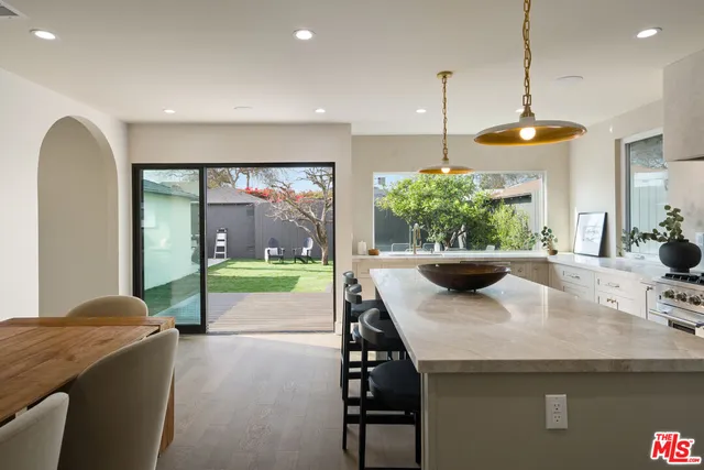 a large kitchen with stainless steel appliances granite countertop a sink and a stove