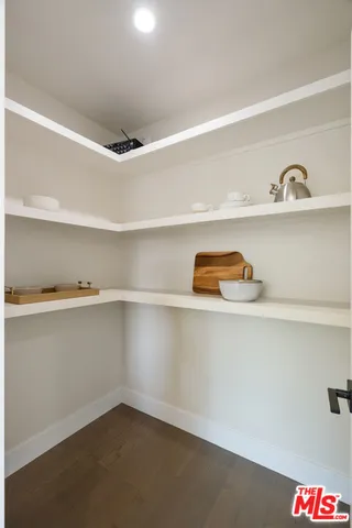 a bedroom with a bed and a mirror