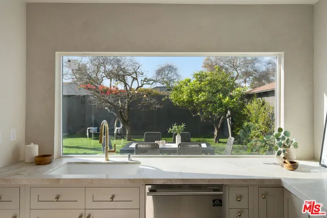 a bedroom with furniture and a large window