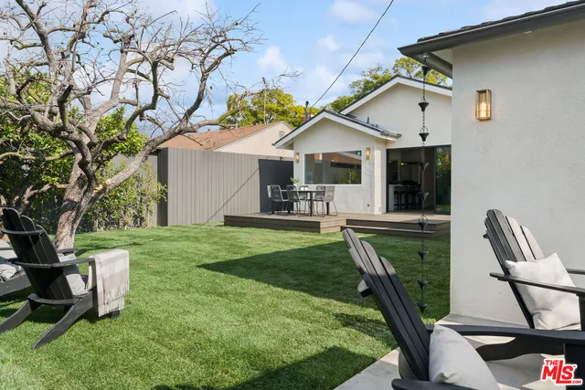 a view of a backyard with sitting area