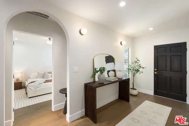 a bedroom with bed and a large window