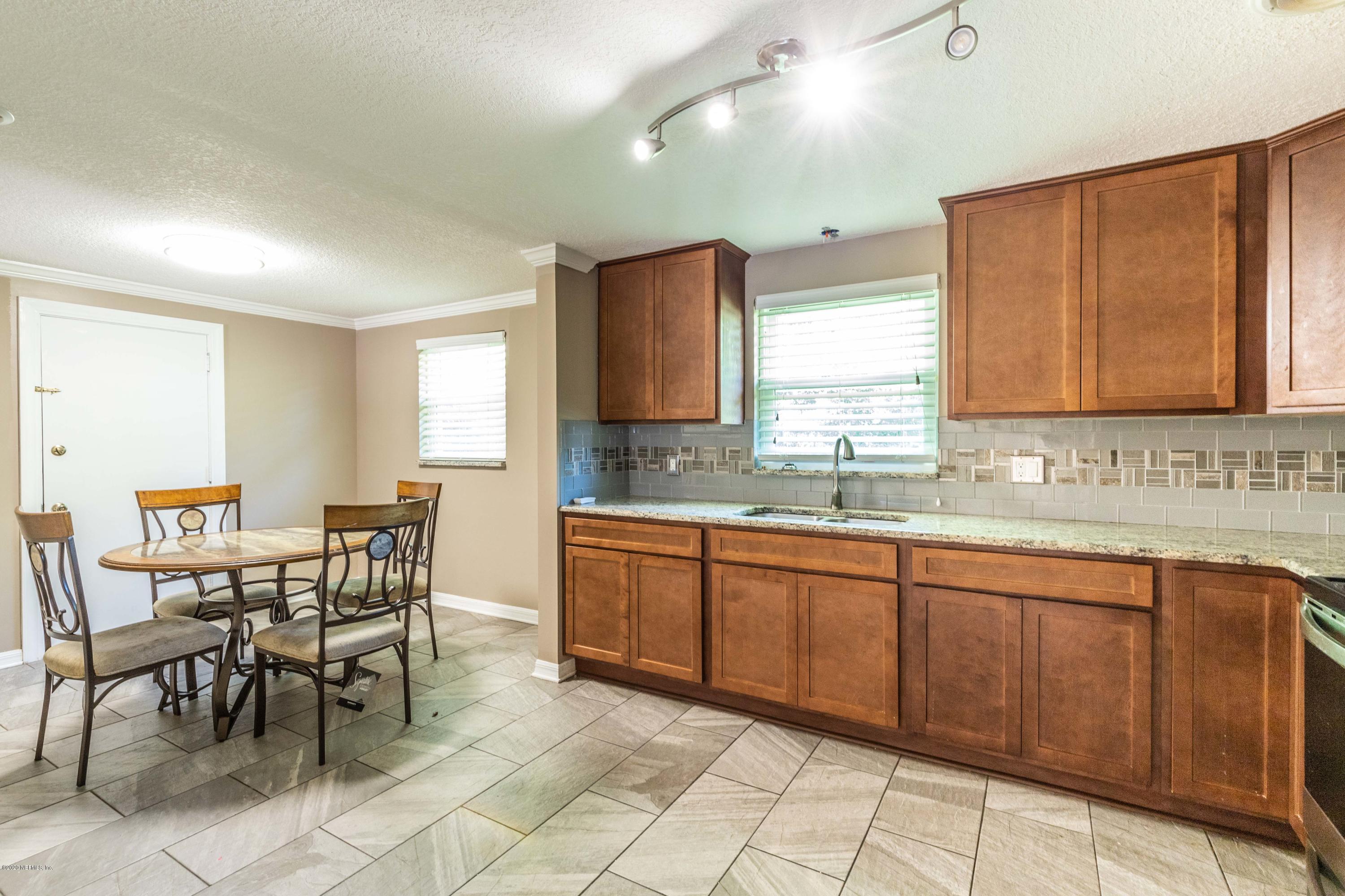5908 Ensenada Road Jacksonville, FL 32244 - Photo 16 of 30 a large kitchen with a table and chairs