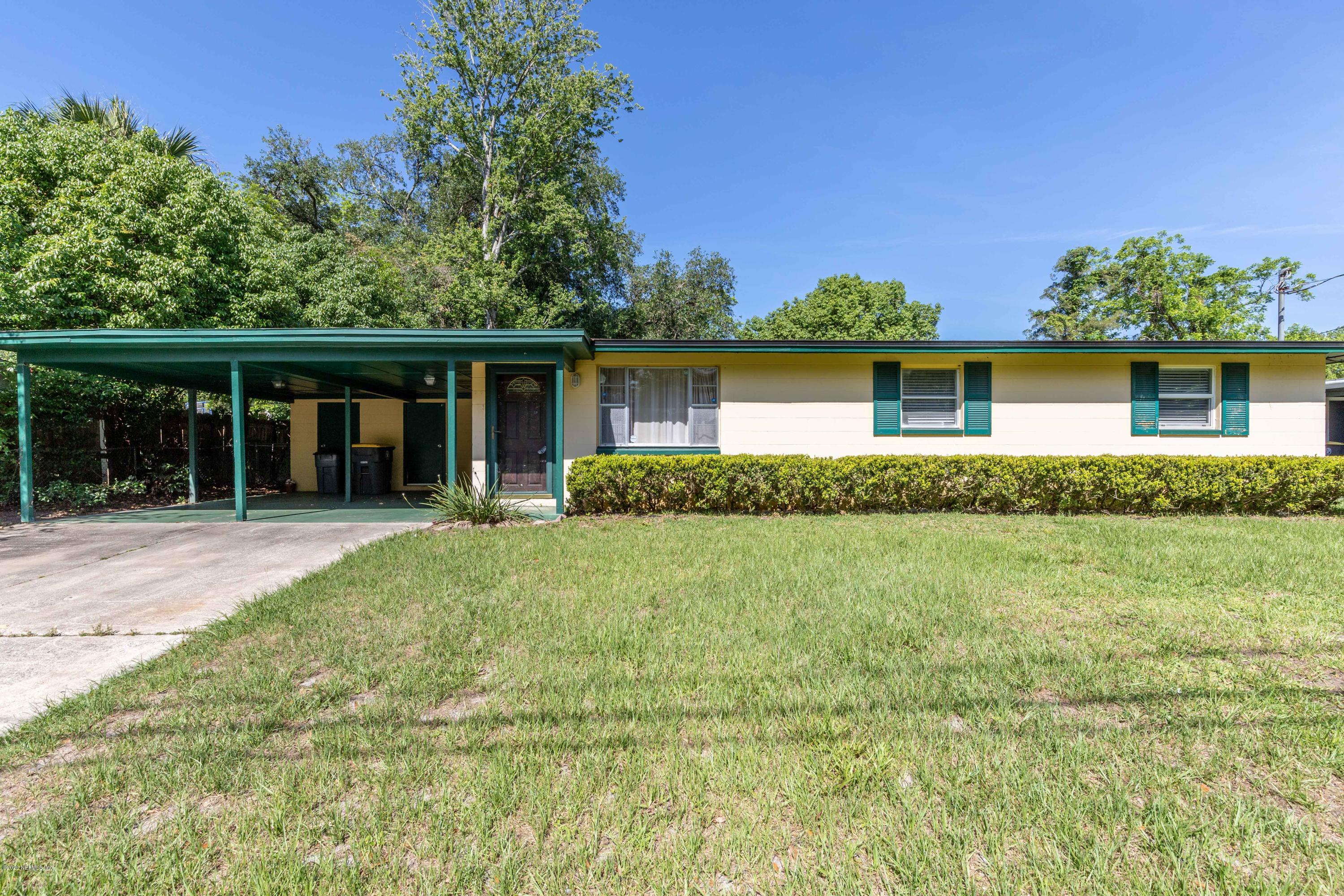 5908 Ensenada Road Jacksonville, FL 32244 - Photo 2 of 30 a front view of a house with a yard and garage