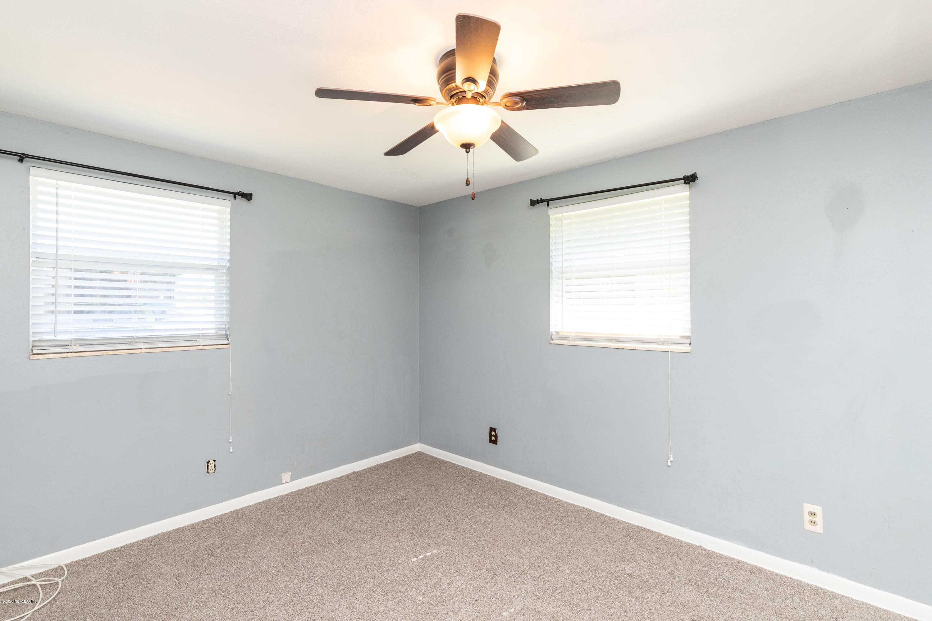 5908 Ensenada Road Jacksonville, FL 32244 - Photo 22 of 30 an empty room with a window and a fan