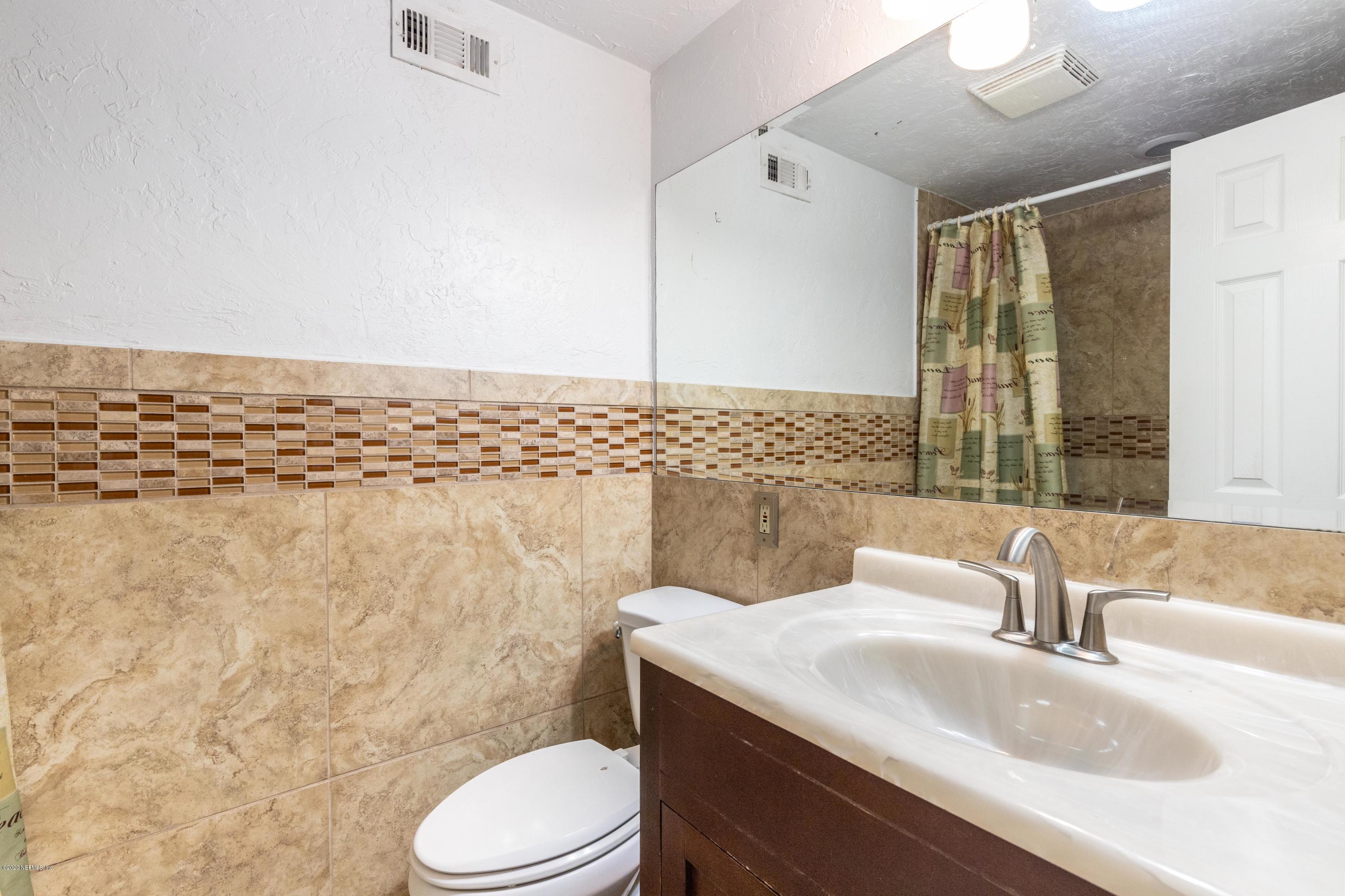 5908 Ensenada Road Jacksonville, FL 32244 - Photo 24 of 30 a bathroom with a sink toilet and shower