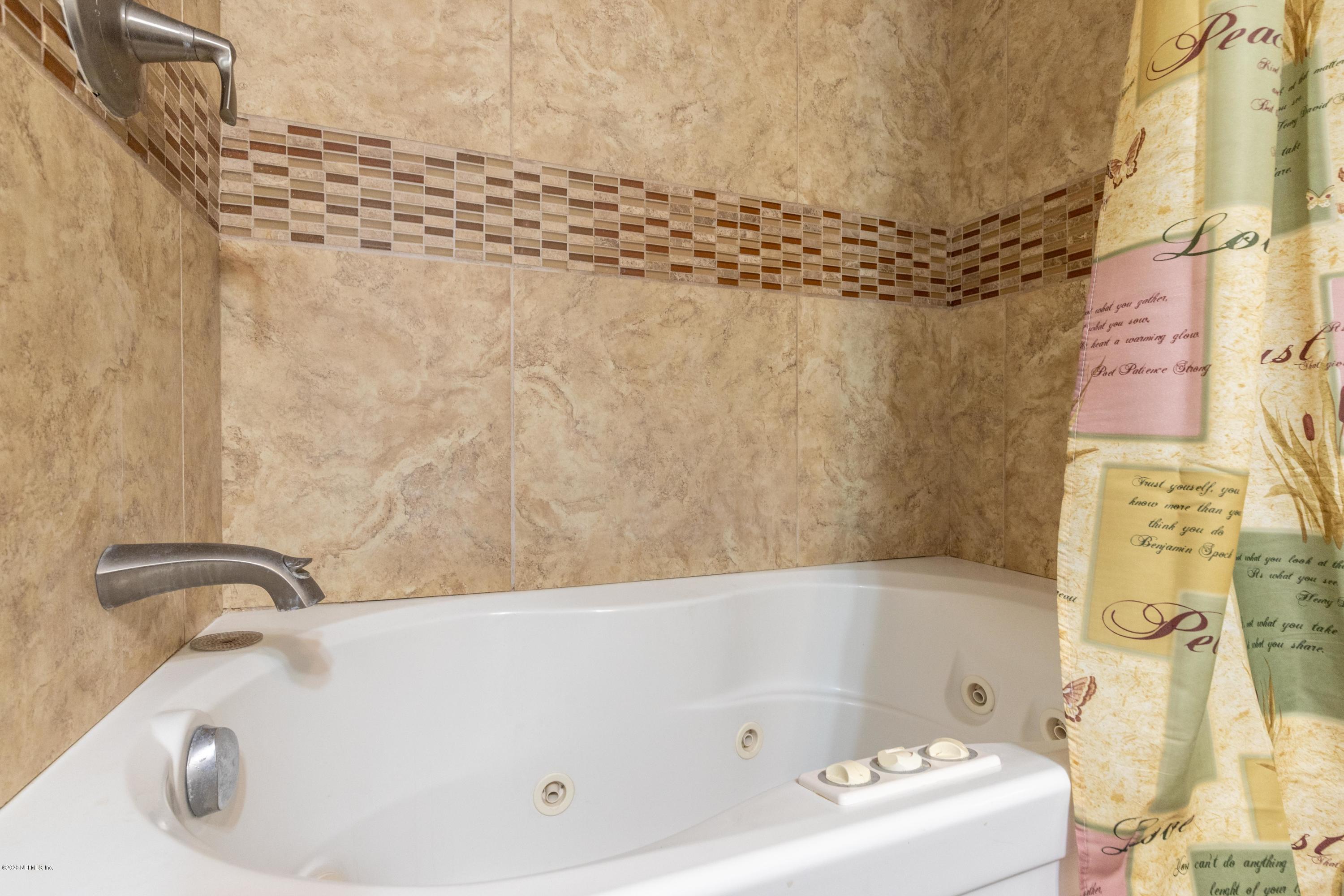 5908 Ensenada Road Jacksonville, FL 32244 - Photo 25 of 30 a bathroom with a bathtub
