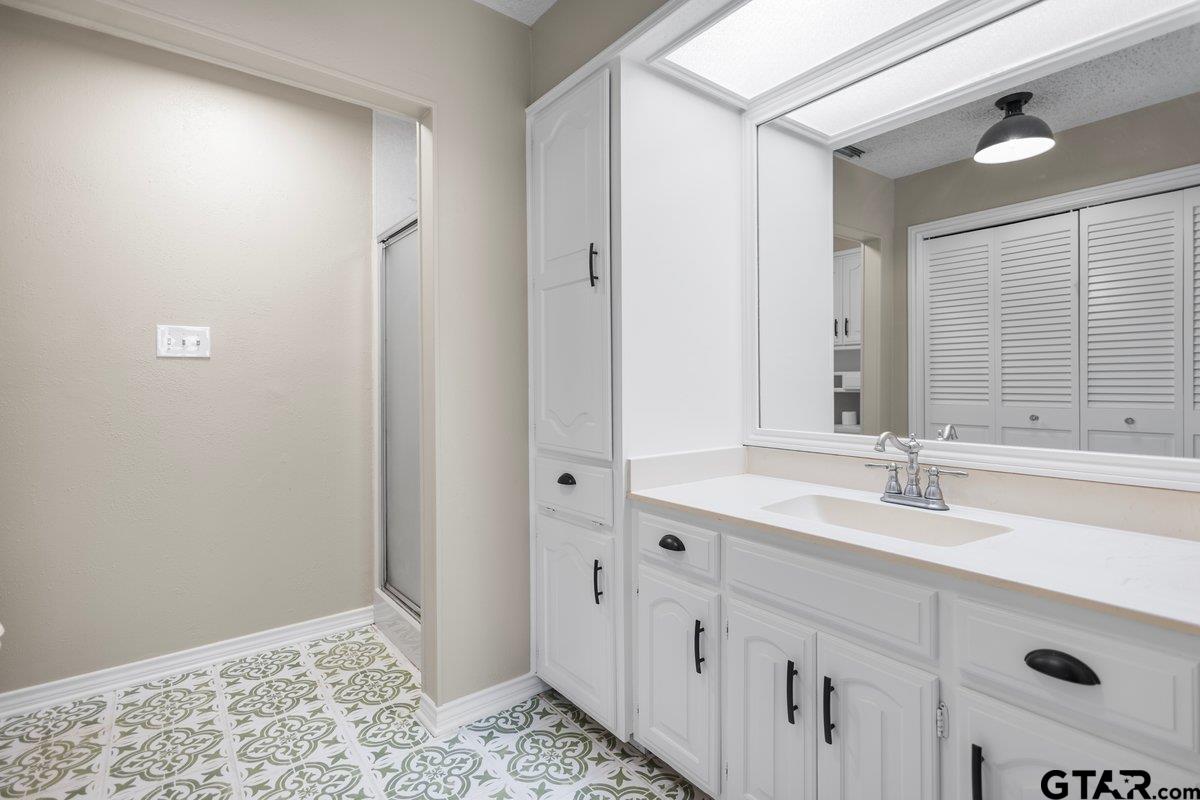 15938 Big Oak Bay Road Tyler, TX 75707 - Photo 12 of 21 a bathroom with a sink and a mirror