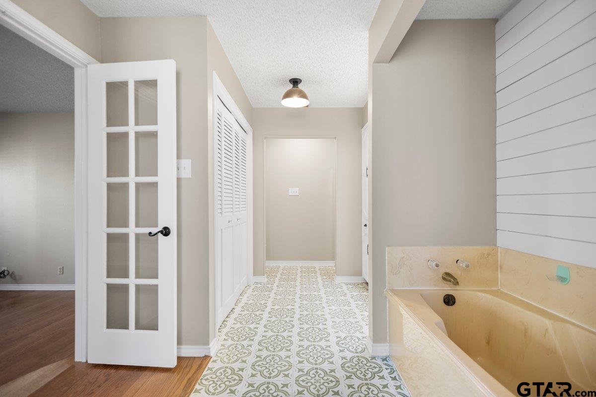 15938 Big Oak Bay Road Tyler, TX 75707 - Photo 14 of 21 a bathroom with a tub shower and a sink