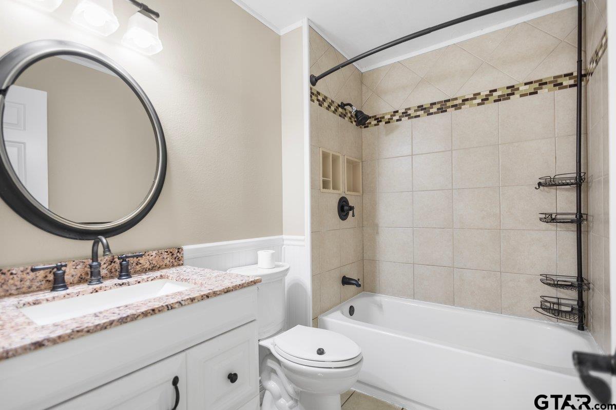 15938 Big Oak Bay Road Tyler, TX 75707 - Photo 19 of 21 a bathroom with a granite countertop sink mirror toilet and bathtub