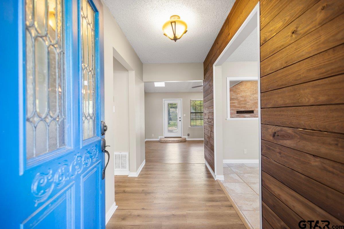 15938 Big Oak Bay Road Tyler, TX 75707 - Photo 3 of 21 a view of a hallway with wooden floor and staircase