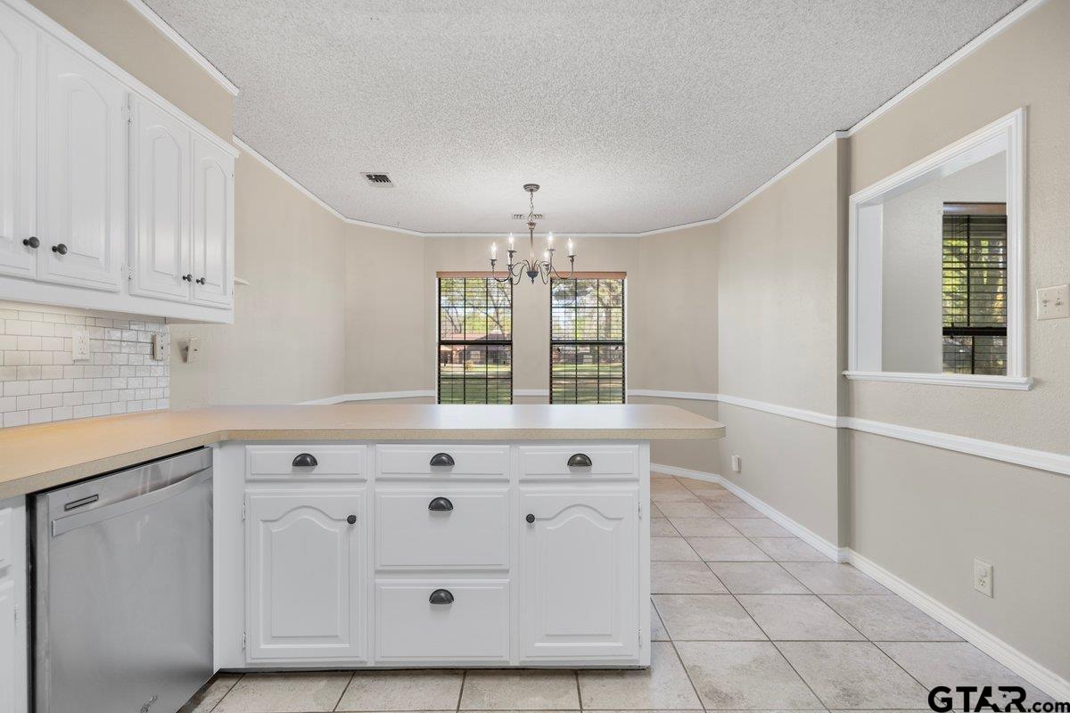 15938 Big Oak Bay Road Tyler, TX 75707 - Photo 6 of 21 a kitchen with white cabinets and window