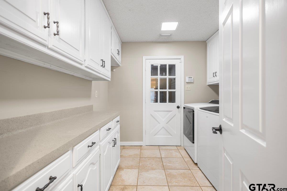 15938 Big Oak Bay Road Tyler, TX 75707 - Photo 8 of 21 a view of a kitchen with white cabinets and white walls