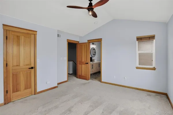 a view of empty room with ceiling fan