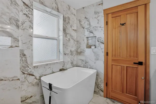 a bathroom with a bathtub and shower