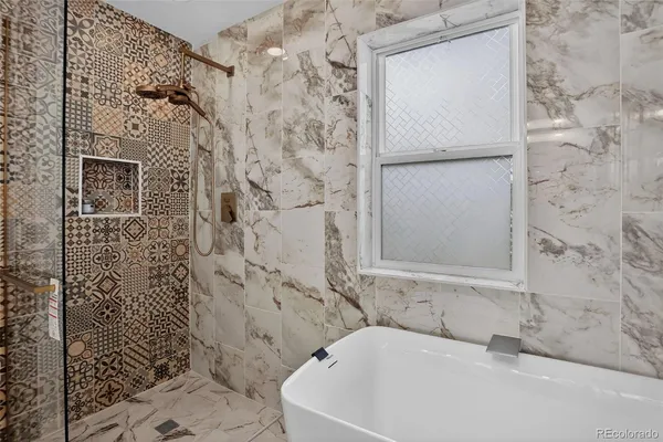a white bath tub sitting next to a white sink and vanity