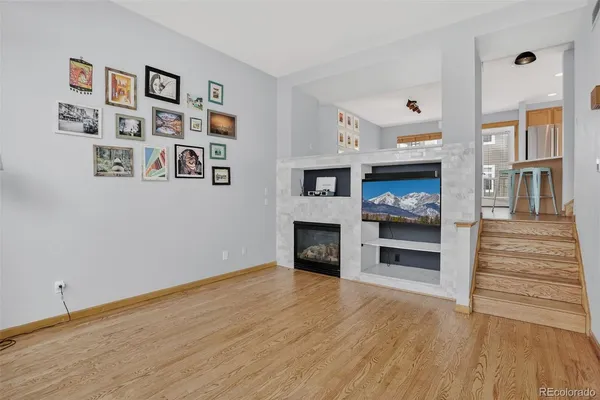 a view of a livingroom with an empty space and a fireplace