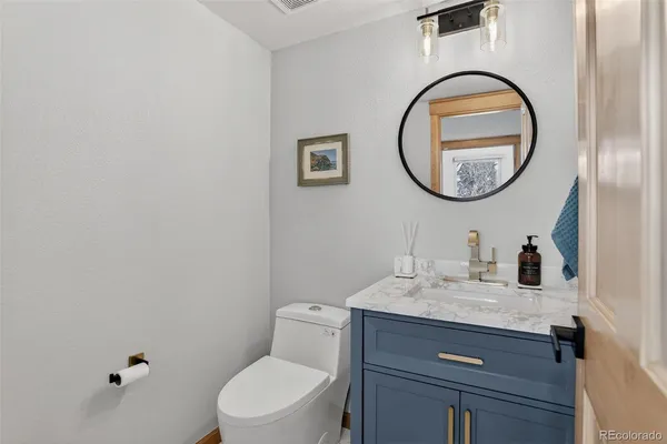 a bathroom with a toilet a sink and a mirror