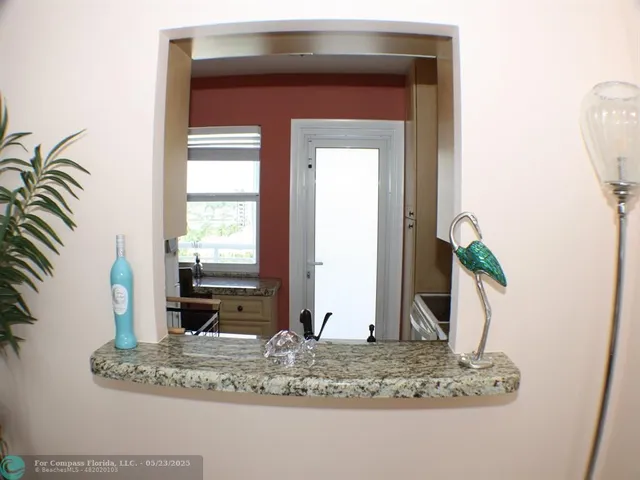 a view of a bathroom sink a mirror and a window