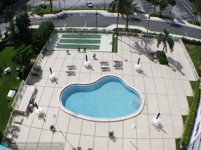a view of a swimming pool with outdoor seating
