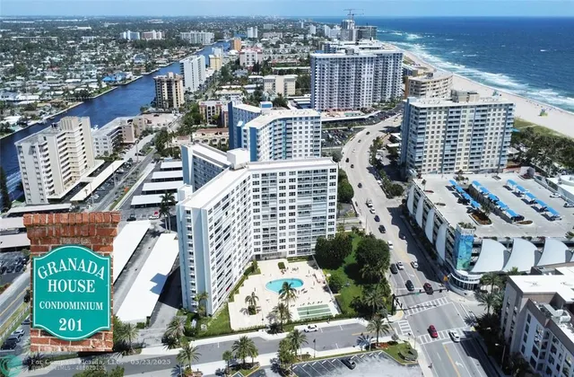an aerial view of residential houses with outdoor space