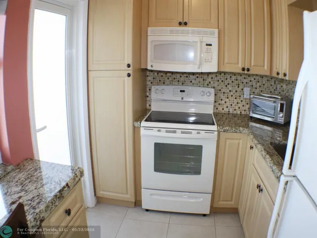 a stove top oven sitting inside of a kitchen