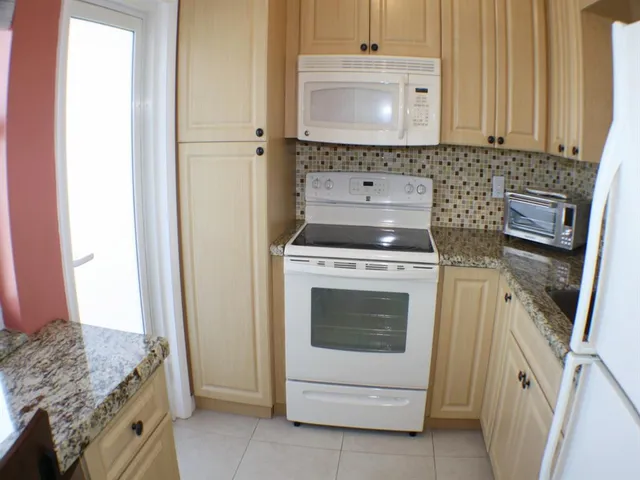 a stove top oven sitting inside of a kitchen