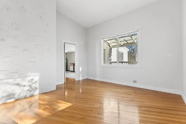 a living room with furniture a table and kitchen view