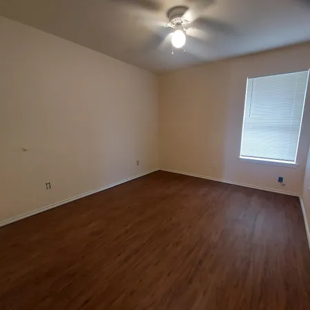 a view of a room with wooden floor and windows