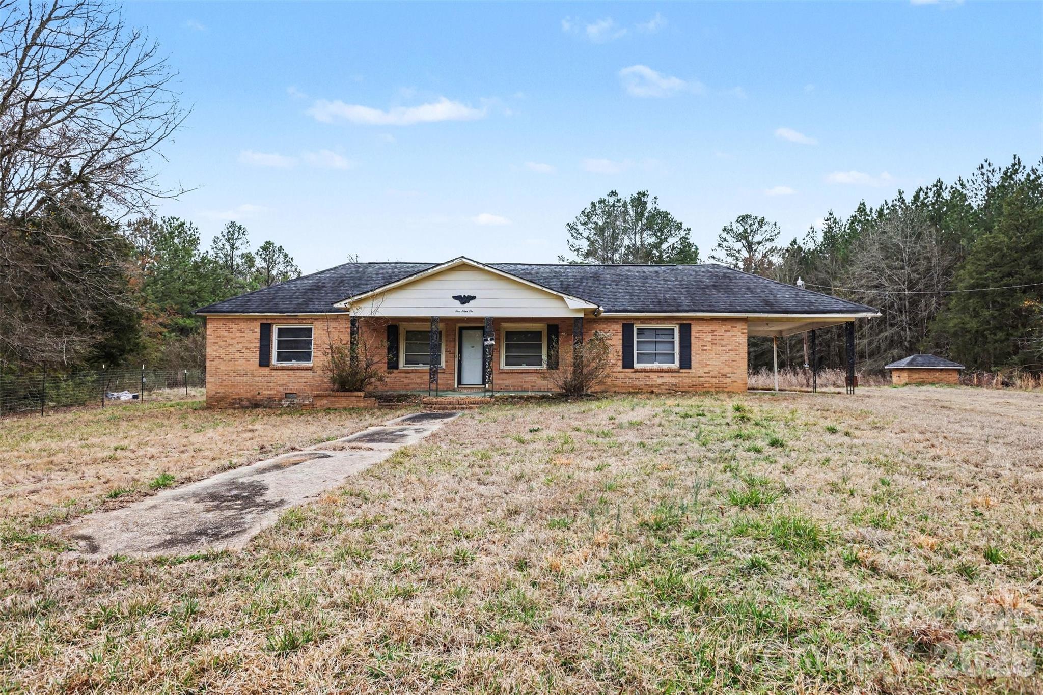 596 Armory Road Chester, SC 29706 - Photo 1 of 25 a front view of a house with a garden and yard