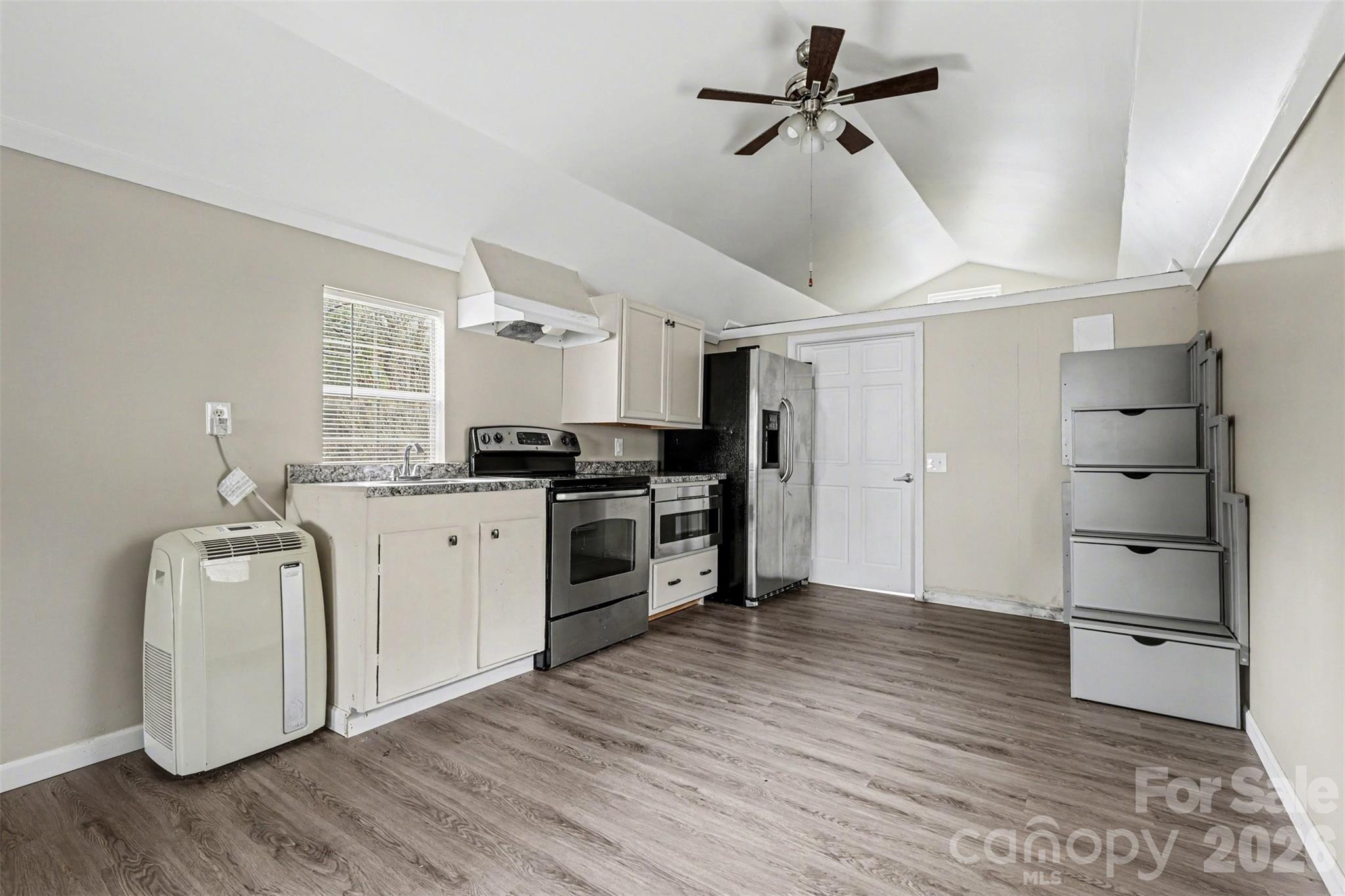 596 Armory Road Chester, SC 29706 - Photo 11 of 25 a kitchen with granite countertop a refrigerator and a stove top oven