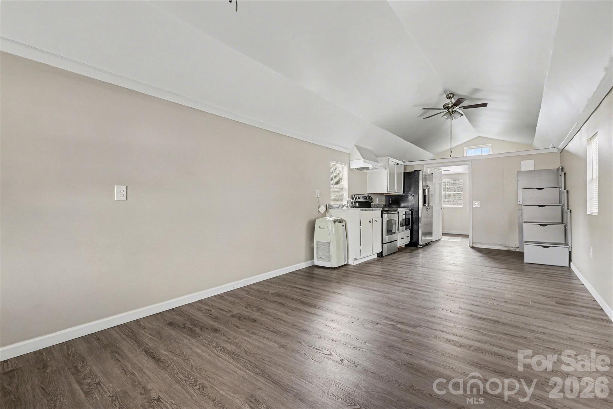 596 Armory Road Chester, SC 29706 - Photo 9 of 25 wooden floor in an empty room with a window and a kitchen
