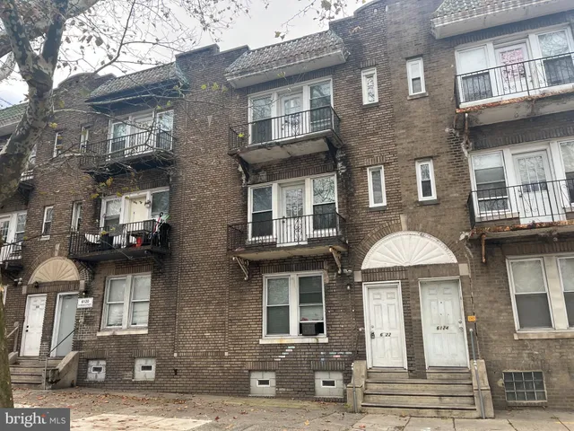 a front view of a residential apartment building with a yard